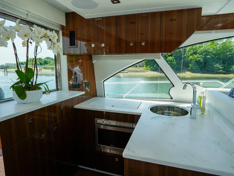 Slide: The Image of Modern kitchen interior of 2021 Cruisers Yachts 50 Cantius with waterfront view. - 23