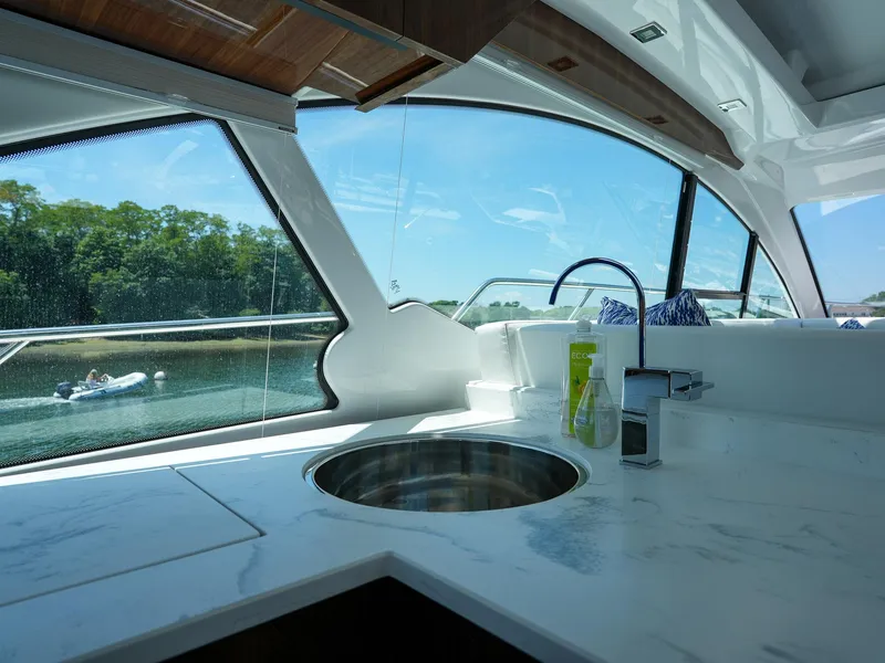 Slide: The Image of Interior view of 2021 Cruisers Yachts 50 Cantius kitchen with marble countertop. - 26