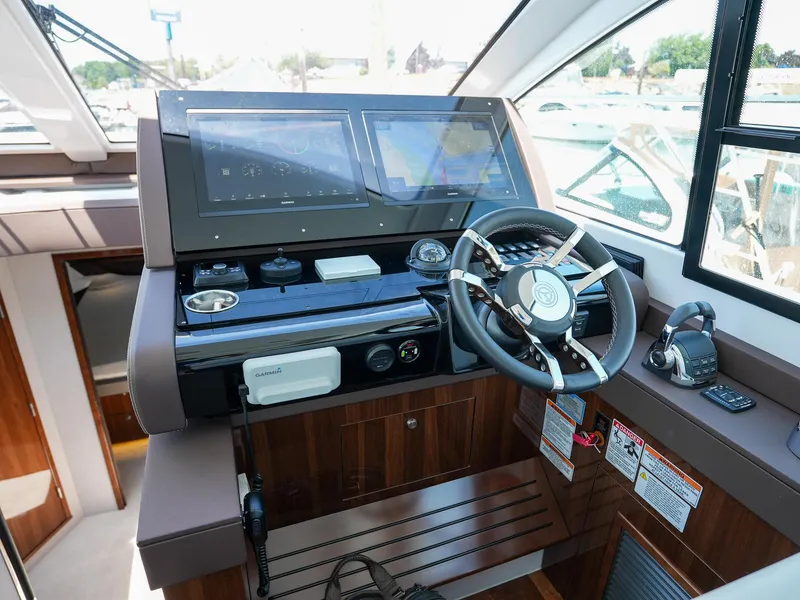 Slide: The Image of 2021 Cruisers Yachts 50 Cantius helm station with dual displays and modern controls. - 35
