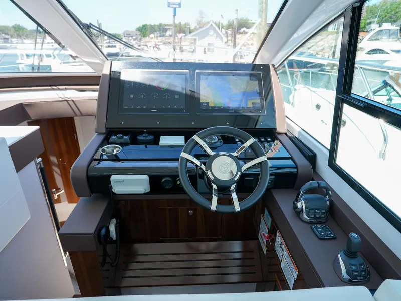Slide: The Image of 2021 Cruisers Yachts 50 Cantius helm with dual displays and modern navigation equipment. - 36