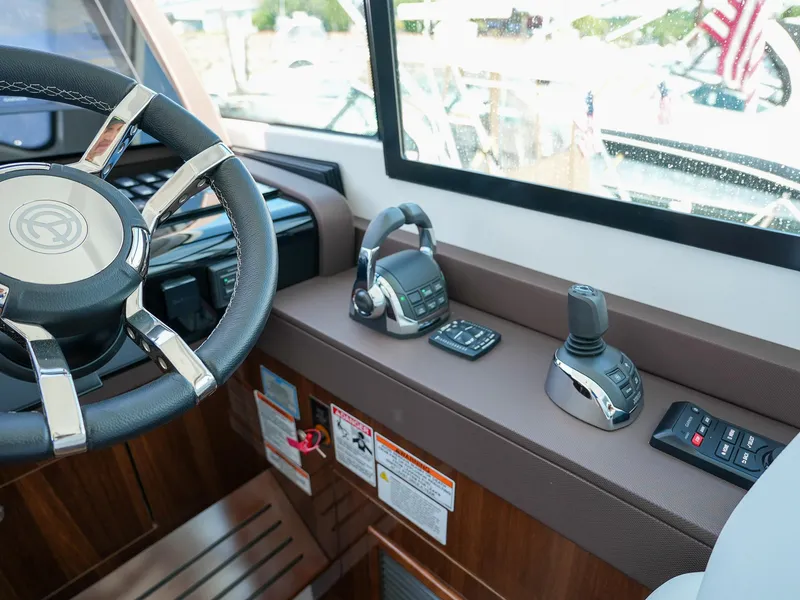 Slide: The Image of 2021 Cruisers Yachts 50 Cantius helm with steering wheel and control panel. - 38