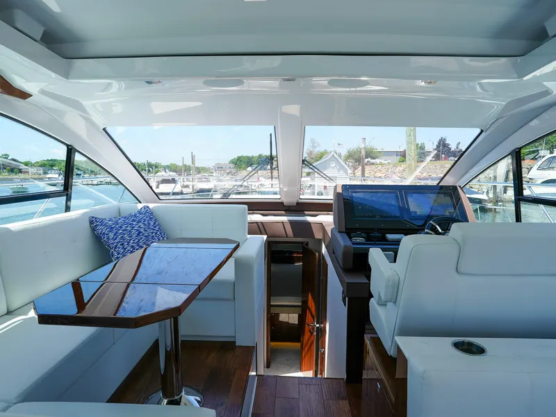 Slide: The Image of Interior of 2021 Cruisers Yachts 50 Cantius with modern seating and navigation area. - 39