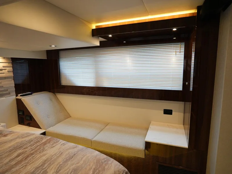 Slide: The Image of 2021 Cruisers Yachts 50 Cantius interior lounge area with modern seating and window blinds. - 45