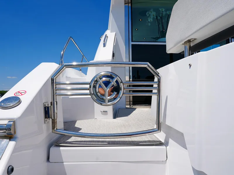 Slide: The Image of 2021 Cruisers Yachts 50 Cantius, luxury yacht entrance gate with chrome detailing. - 9