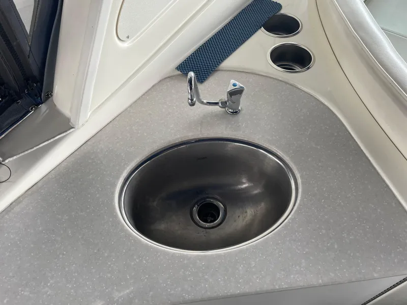 Slide: The Image of 2008 Bayliner 340 boat sink and countertop with cup holders. - 11