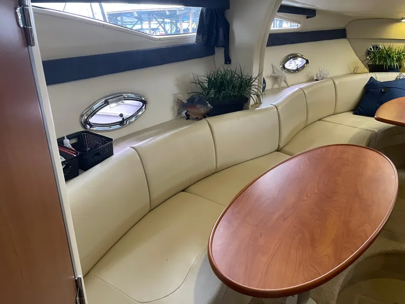 Slide: The Image of 2008 Bayliner 340 yacht interior with curved leather seating and wooden table. - 17