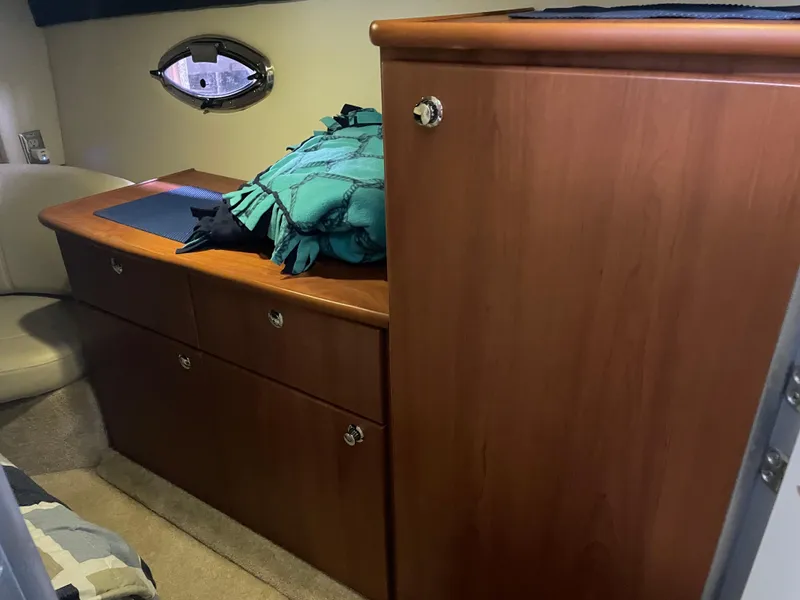 Slide: The Image of Interior cabin of 2008 Bayliner 340 boat with wooden cabinetry and porthole window. - 21