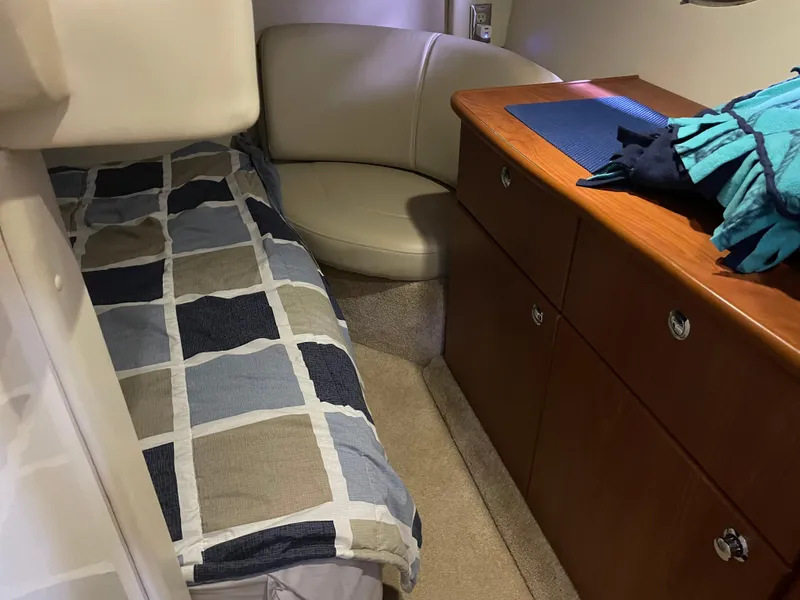 Slide: The Image of 2008 Bayliner 340 cabin interior with bed, seating, and storage drawers. - 22