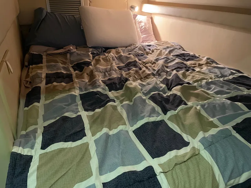 Slide: The Image of Cozy sleeping area in 2008 Bayliner 340 boat with patterned bedding. - 23