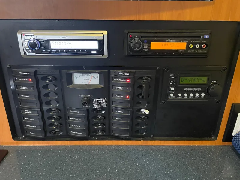 Slide: The Image of Control panel of a 2008 Bayliner 340 boat with various switches and gauges. - 29