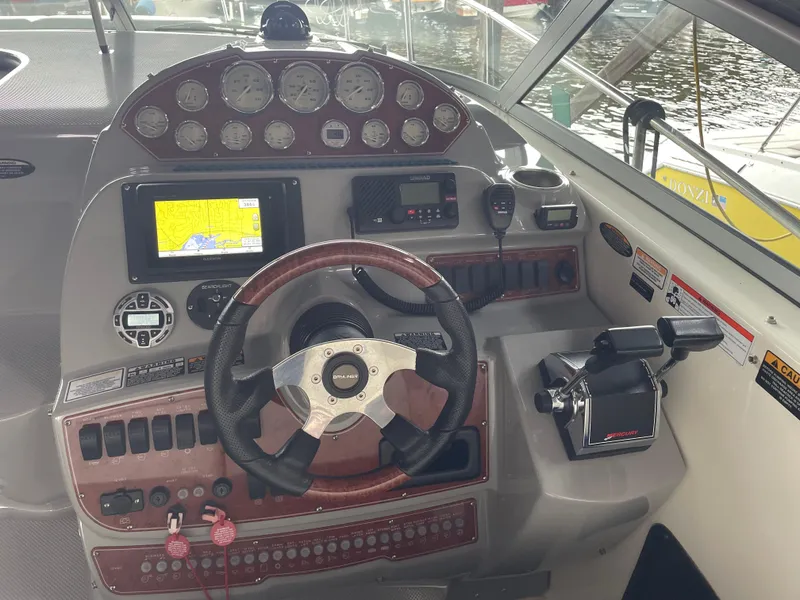 Slide: The Image of 2008 Bayliner 340 boat dashboard with steering wheel, gauges, and navigation system. - 4