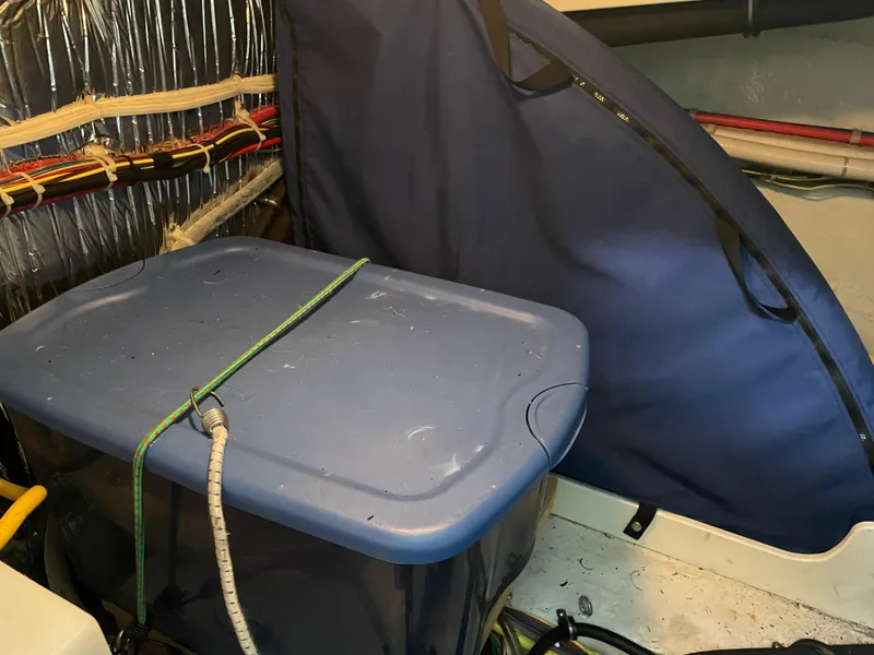 Slide: The Image of Storage area in a 2008 Bayliner 340 boat with blue container and cover. - 41