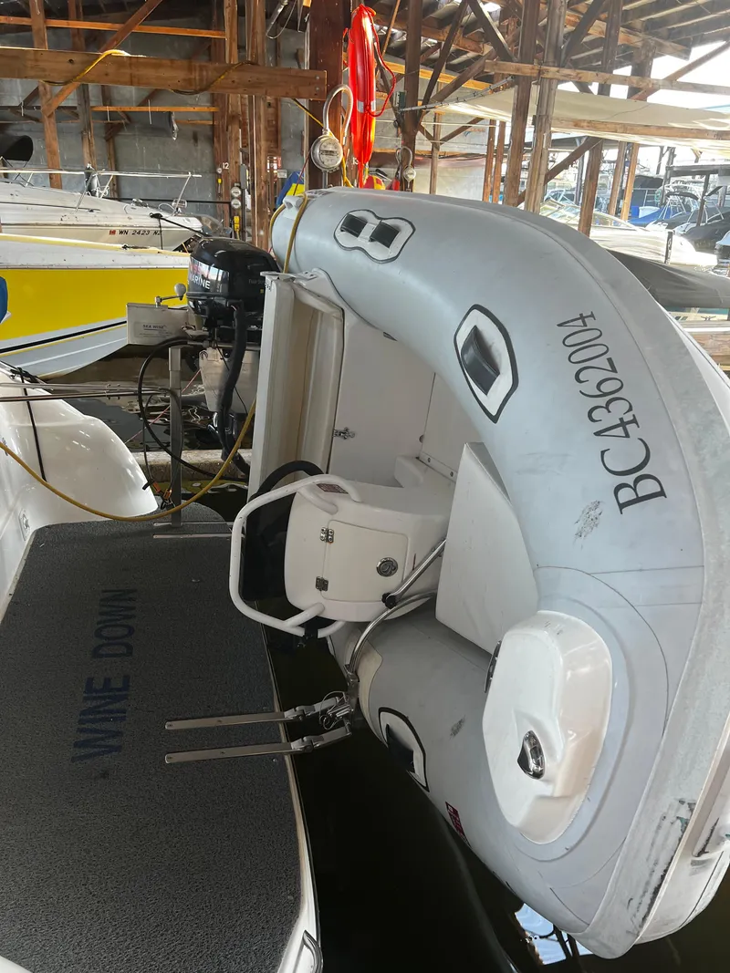 Slide: The Image of 2008 Bayliner 340 with attached dinghy in a marina. - 43