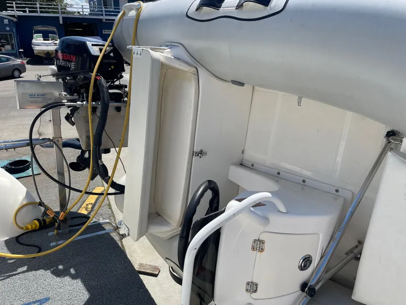 Slide: The Image of 2008 Bayliner 340 boat stern with outboard motor and storage compartments. - 44