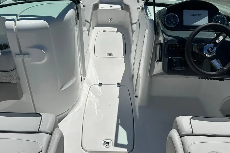 Slide: The Image of Interior view of 2026 Hurricane SunDeck 2400 OB boat, featuring steering console and seating. - 10