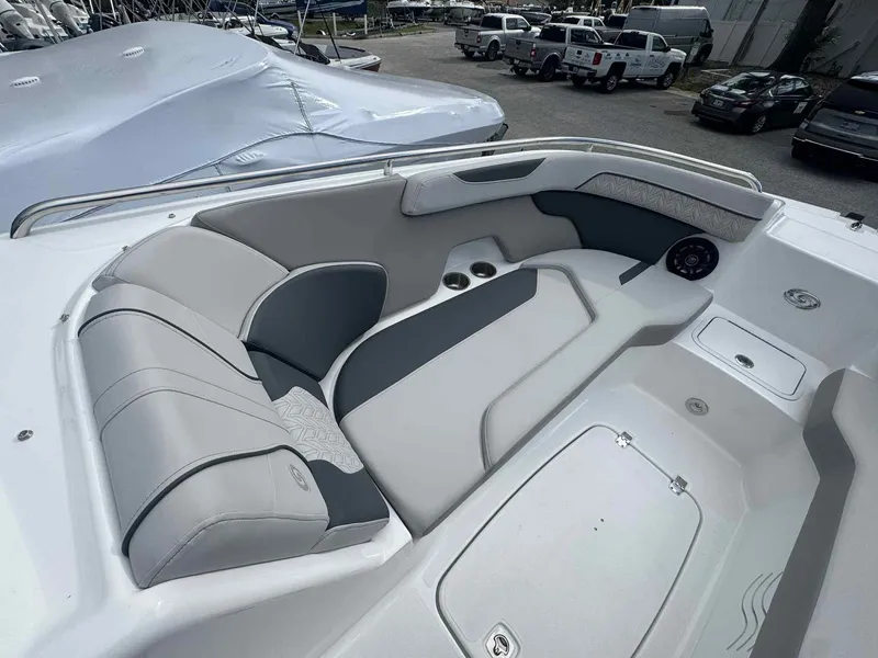 Slide: The Image of 2025 Hurricane SunDeck 2400 OB boat interior with gray seating and cup holders. - 12