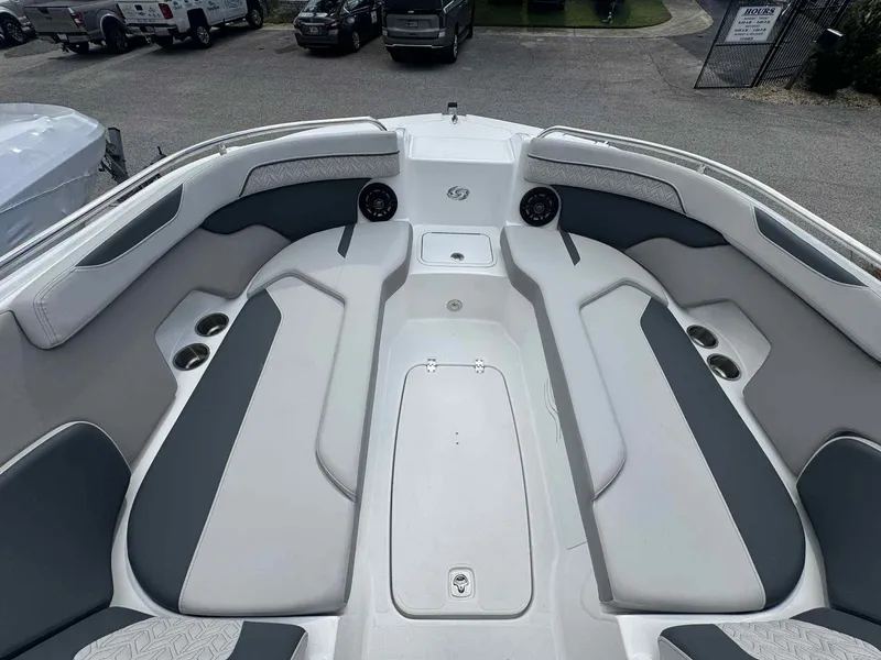 Slide: The Image of 2025 Hurricane SunDeck 2400 OB boat interior with spacious seating and cup holders. - 14