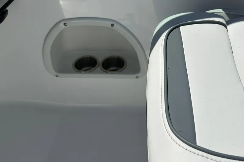 Slide: The Image of Interior of 2026 Hurricane SunDeck 2400 OB featuring cup holders and cushioned seating. - 22