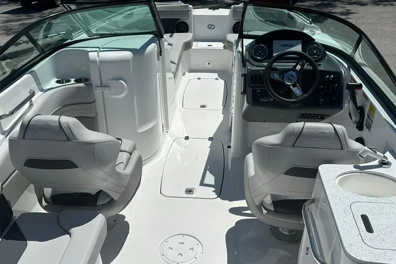 Slide: The Image of 2026 Hurricane SunDeck 2400 OB boat interior with modern seating and steering console. - 23