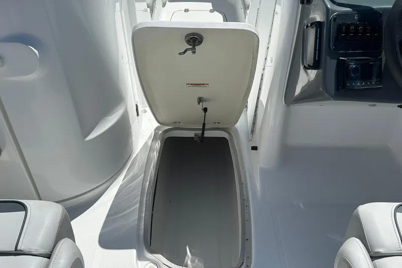 Slide: The Image of 2026 Hurricane SunDeck 2400 OB boat storage compartment open, showcasing interior space. - 24