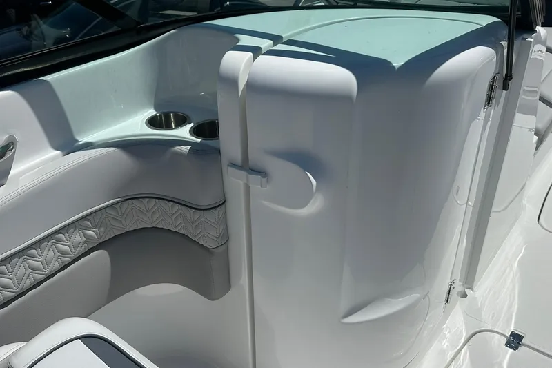 Slide: The Image of 2026 Hurricane SunDeck 2400 OB boat interior with cup holders and sleek white design. - 25
