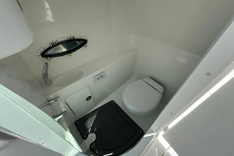 Slide: The Image of 2026 Hurricane SunDeck 2400 OB boat bathroom with toilet and sink. - 28