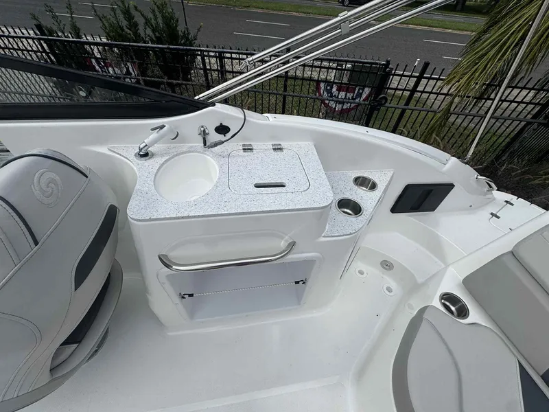 Slide: The Image of 2025 Hurricane SunDeck 2400 OB boat interior with sink and seating area. - 3
