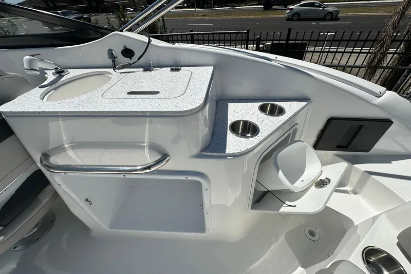 Slide: The Image of Interior view of 2026 Hurricane SunDeck 2400 OB boat with sink and cup holders. - 30