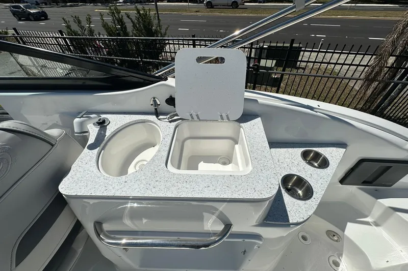 Slide: The Image of 2026 Hurricane SunDeck 2400 OB boat interior with sink and countertop amenities. - 31