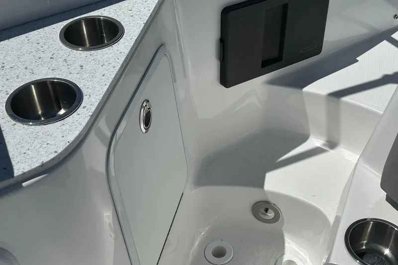 Slide: The Image of Interior of 2026 Hurricane SunDeck 2400 OB boat with cup holders and storage compartment. - 32