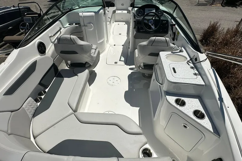 Slide: The Image of 2026 Hurricane SunDeck 2400 OB boat interior with seating, steering, and kitchenette area. - 33