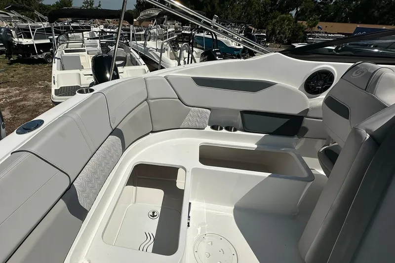 Slide: The Image of 2026 Hurricane SunDeck 2400 OB boat interior with seating and storage compartments. - 36
