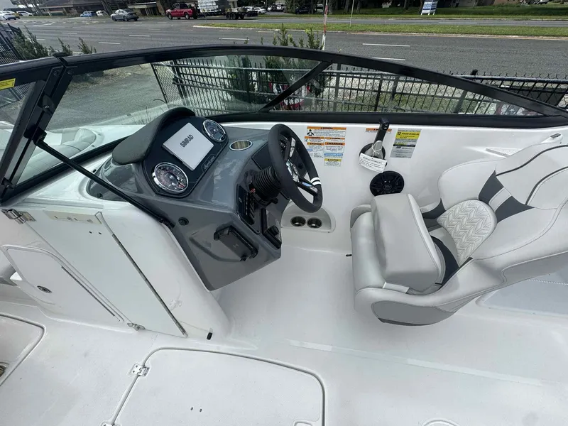 Slide: The Image of 2025 Hurricane SunDeck 2400 OB boat interior with steering console and seating. - 4
