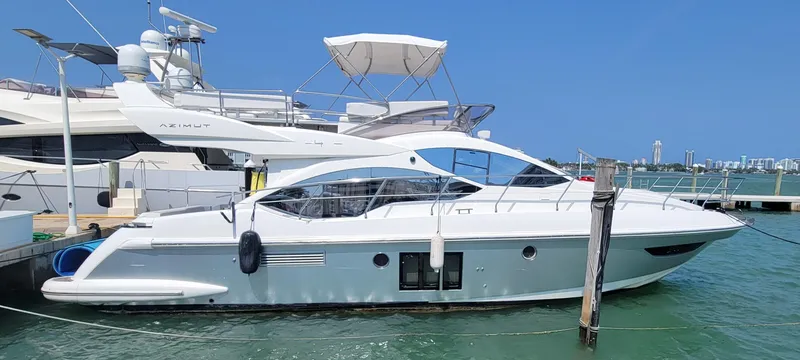 The Image of 2013 Azimut 45 Flybridge yacht docked in marina, clear blue sky. - 0