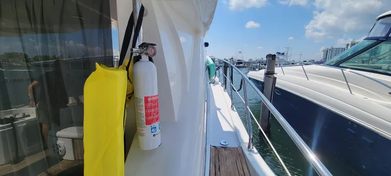 Slide: The Image of Side deck of a 2013 Azimut 45 Flybridge yacht docked at a marina. - 10