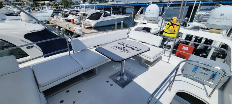 Slide: The Image of 2013 Azimut 45 Flybridge yacht with spacious seating and table on the deck. - 12