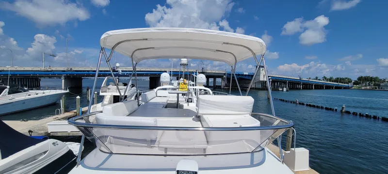 Slide: The Image of 2013 Azimut 45 Flybridge yacht docked at marina under clear blue sky. - 23