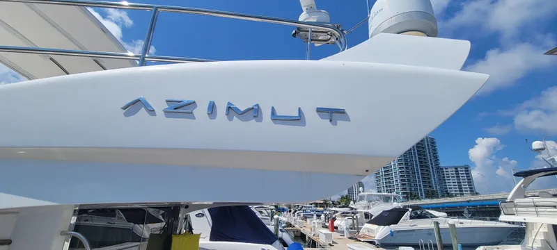 Slide: The Image of 2013 Azimut 45 Flybridge yacht docked at a marina on a sunny day. - 24