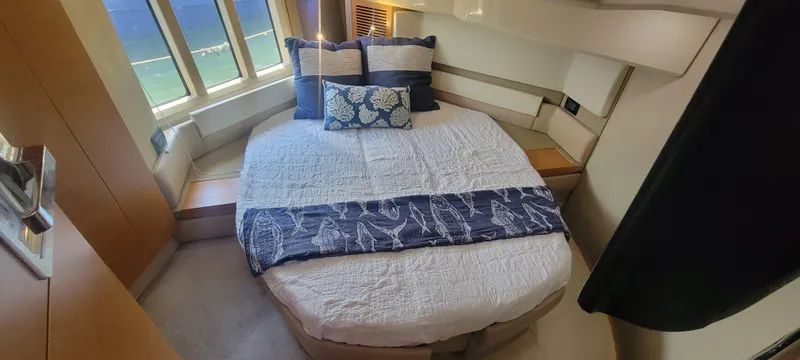 Slide: The Image of Luxurious bedroom interior of 2013 Azimut 45 Flybridge yacht with large windows and elegant bedding. - 25