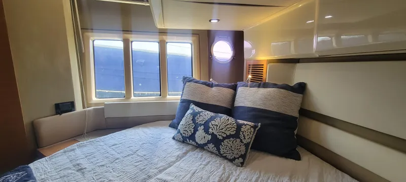 Slide: The Image of Luxurious bedroom interior of 2013 Azimut 45 Flybridge yacht with cozy bedding and ample natural light. - 26