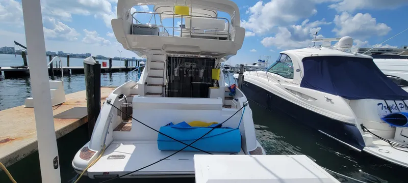 Slide: The Image of 2013 Azimut 45 Flybridge yacht docked at a marina on a sunny day. - 3