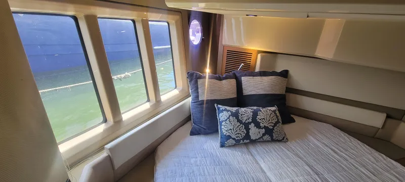 Slide: The Image of Luxurious bedroom interior of 2013 Azimut 45 Flybridge yacht with large windows and plush pillows. - 31
