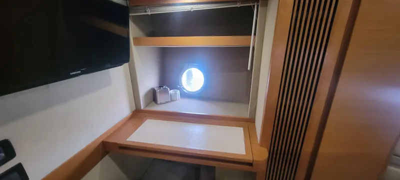 Slide: The Image of Interior cabin of 2013 Azimut 45 Flybridge yacht with desk and porthole. - 38