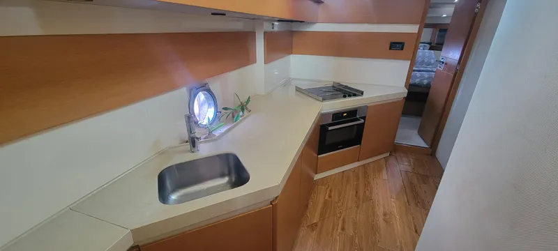 Slide: The Image of 2013 Azimut 45 Flybridge yacht kitchen with modern appliances and wood flooring. - 48