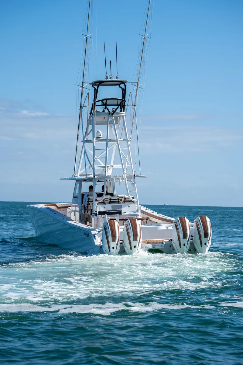 Slide: The Image of Freeman 47 boat 2022 model with multiple outboard engines on open water. - 1