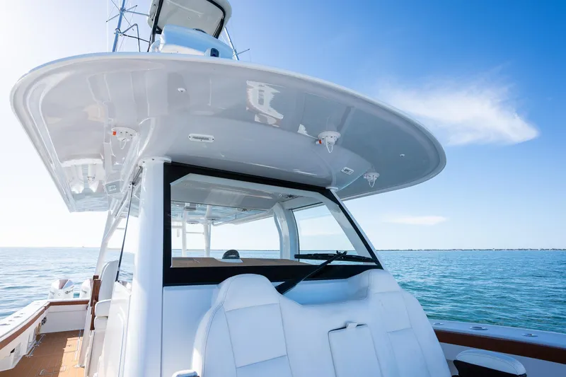 Slide: The Image of Freeman 47 boat, 2022 model, cruising on calm blue waters under a clear sky. - 11