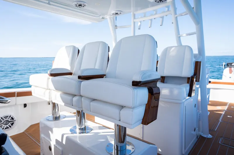 Slide: The Image of Luxury seating on a 2022 Freeman 47 boat with ocean backdrop. - 18