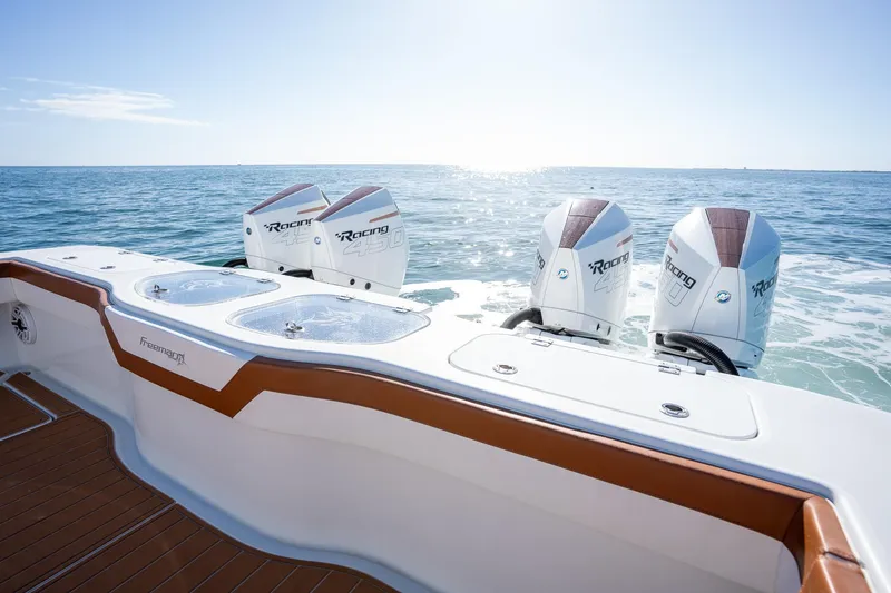 Slide: The Image of Freeman 47 boat with four powerful outboard engines on the open sea, 2022 model. - 28
