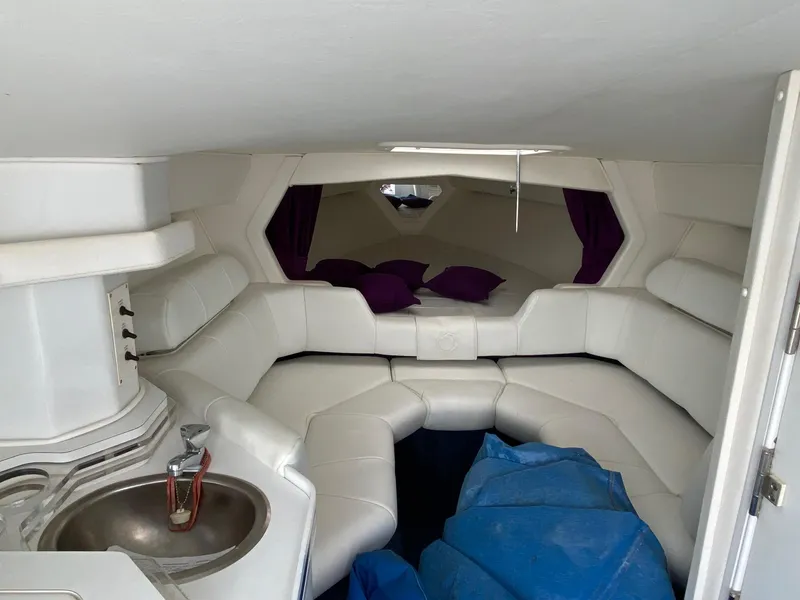 Slide: The Image of Interior of 1998 Fountain 35 Lightning boat with white seating and small sink. - 10
