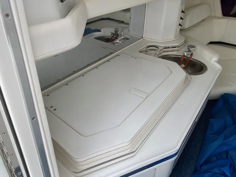 Slide: The Image of 1998 Fountain 35 Lightning boat interior with white seating and sink. - 11